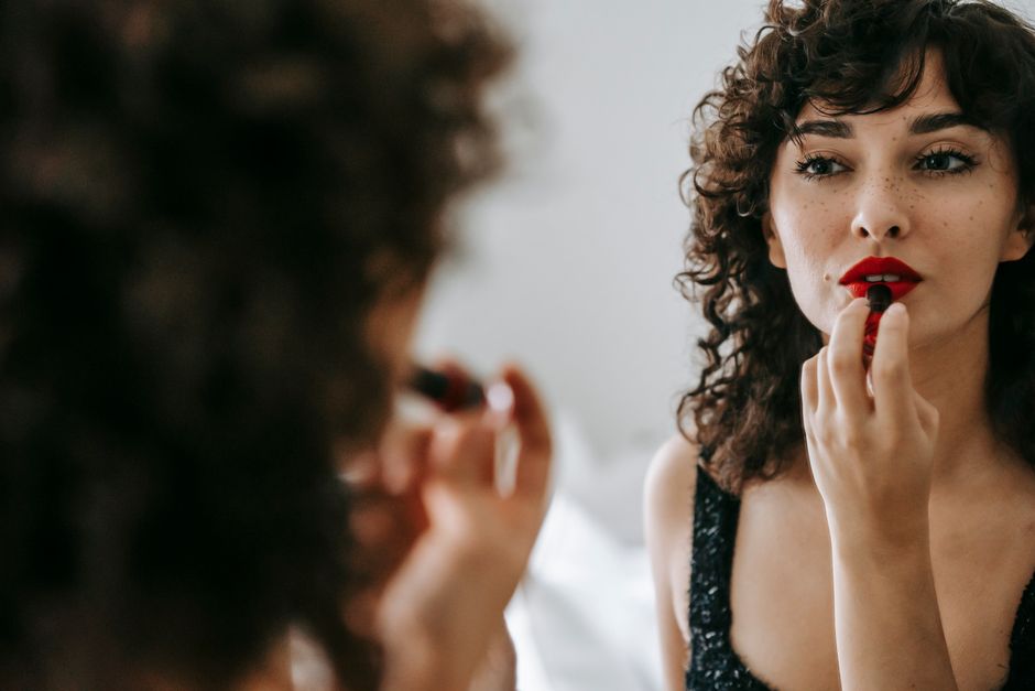 Applying long-wear lipstick for a holiday look