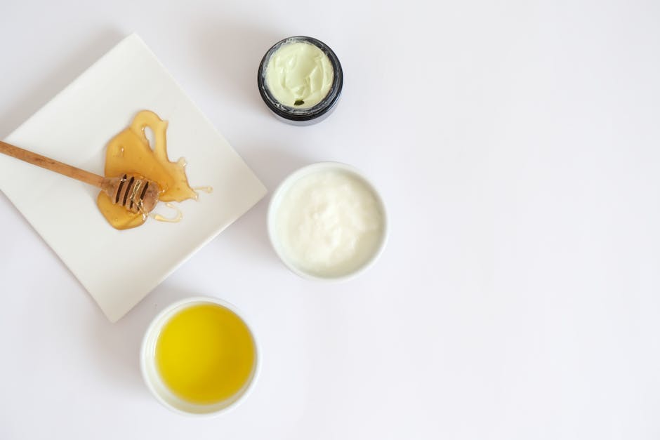 Flat lay image of honey, cream, oil, and natural ingredients for skincare.
