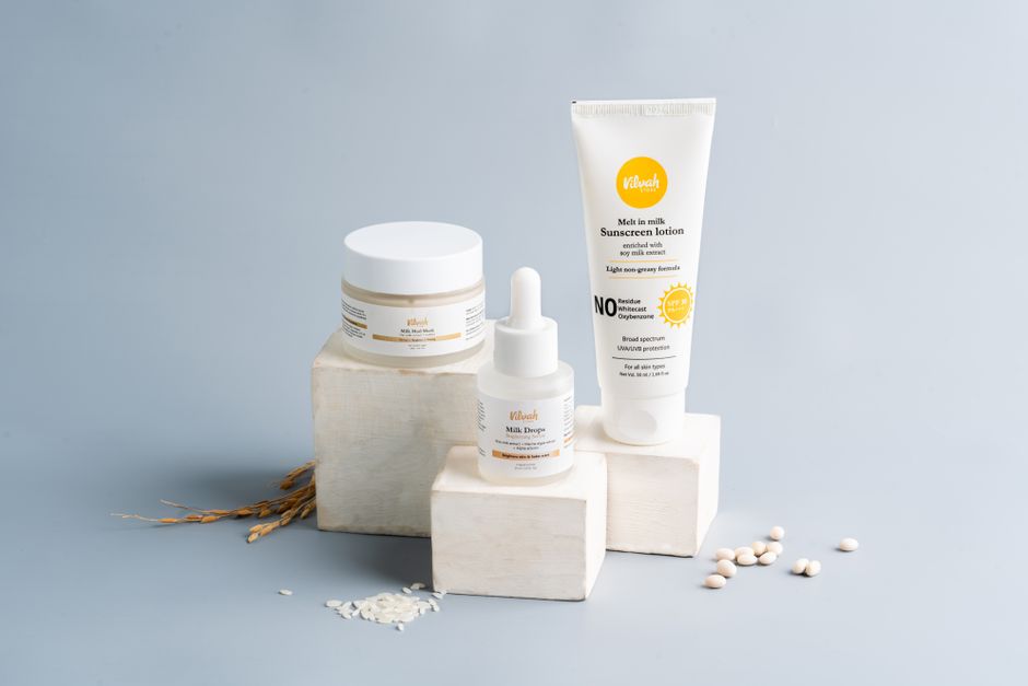 Elegant skincare and sunscreen products on a gray backdrop. Ideal for beauty marketing.
