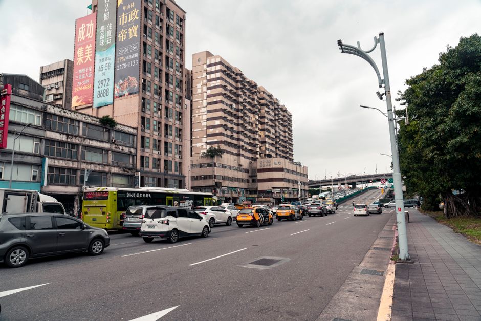 Bustling urban street scene in Taipei City, Taiwan, showcasing traffic and city life.