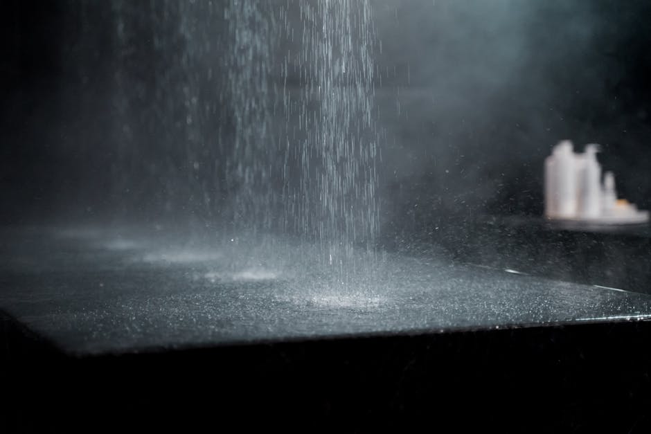Artistic capture of water drops splashing on a dark surface, evoking a sense of calm and tranquility.